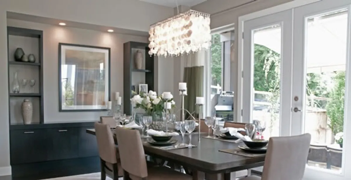 Elegant dining room chandelier installation above table in Boca Raton, FL