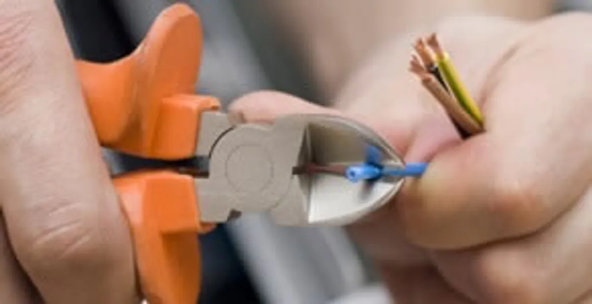 licensed electrician performing precise wire cutting and preparation during electrical service in Boca Raton, FL