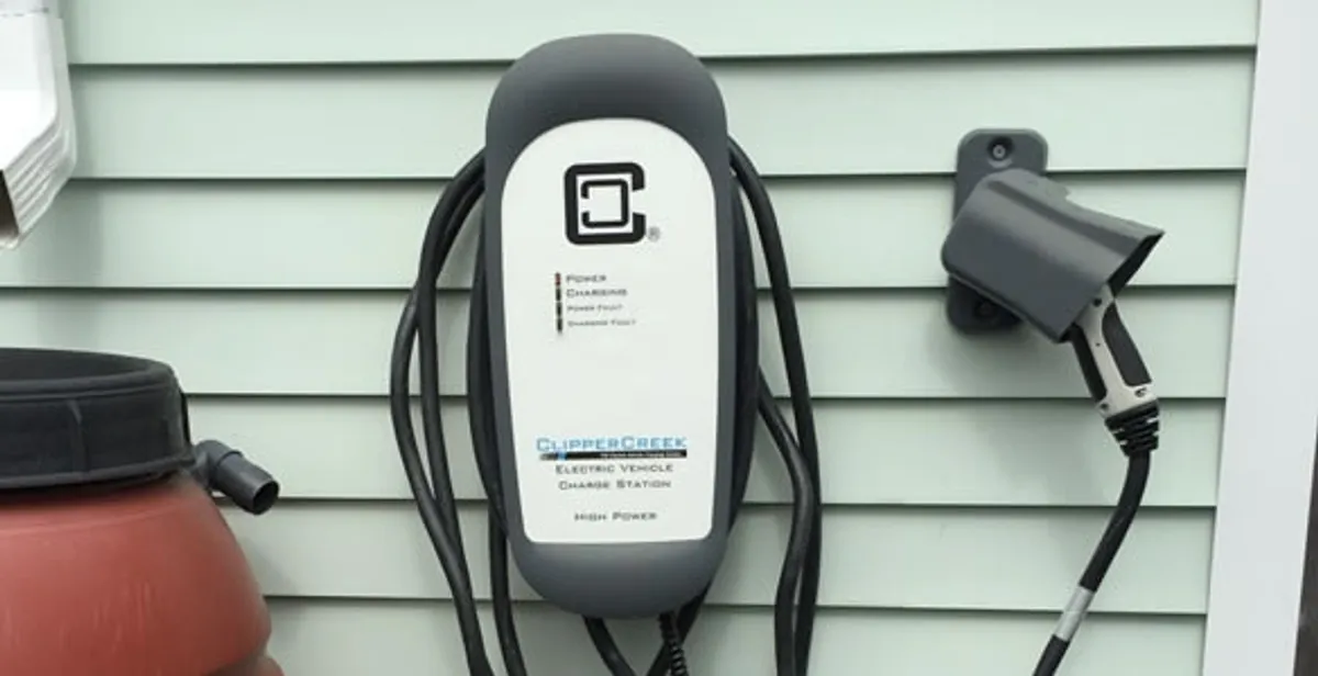 Outdoor electric vehicle charger installation on residential wall in Boca Raton, FL